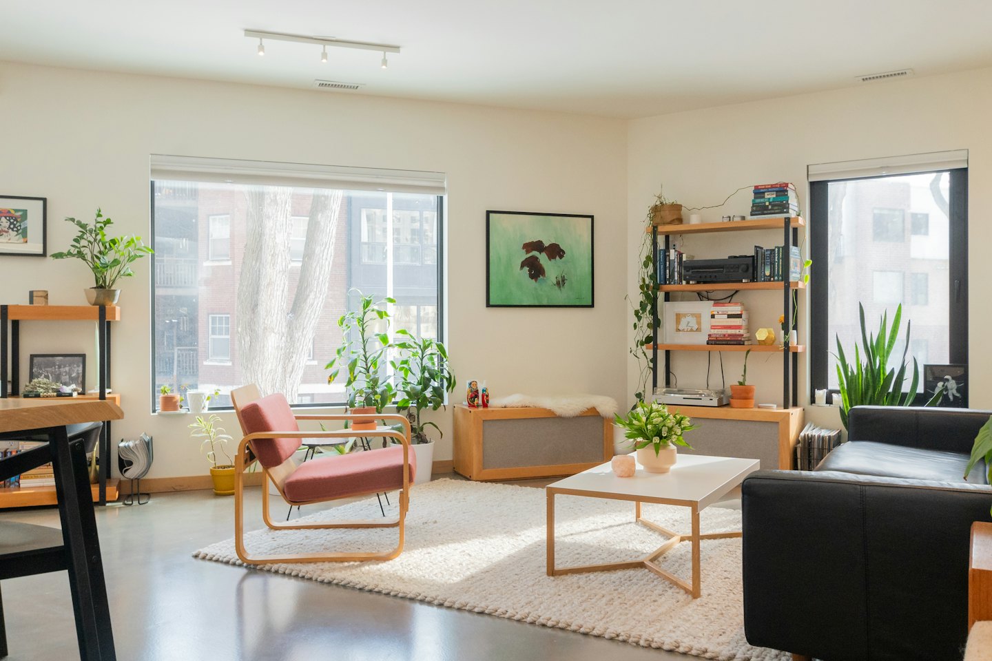 Modernes Wohnzimmer mit rotem Sessel und Pflanzen.